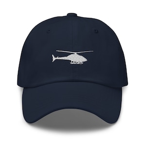 May include: A navy blue baseball cap with a white embroidered helicopter design.
