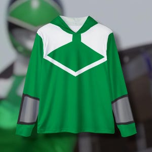 May include: Green long-sleeved shirt with a white diamond shape on the front and gray accents on the sleeves.