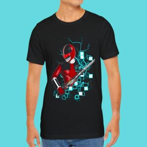 May include: Black t-shirt featuring a red and white illustration of a character in a helmet and suit, holding a sword. The design includes blue lightning bolts and square accents. The shirt is a crew neck.