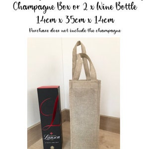 May include: A natural tan burlap bag with handles, measuring 14 inches by 35 inches by 14 inches. The bag is large enough to hold a champagne box or two wine bottles. The bag is shown next to a bottle of Lanson champagne.