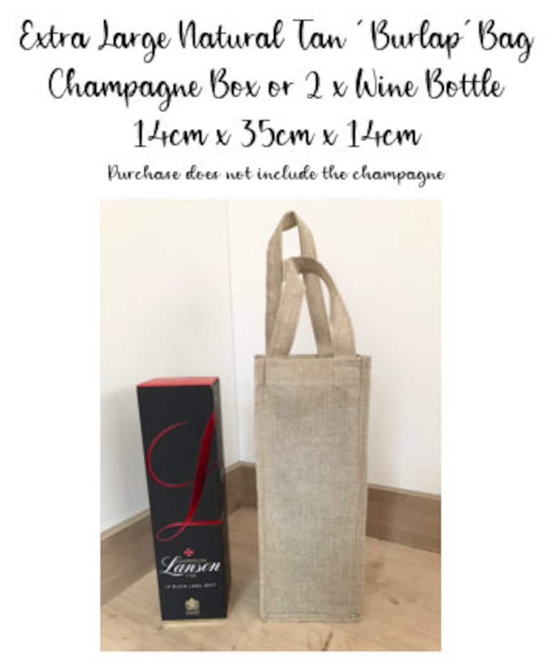 May include: A natural tan burlap bag with handles, measuring 14 inches by 35 inches by 14 inches. The bag is large enough to hold a champagne box or two wine bottles. The bag is shown next to a bottle of Lanson champagne.