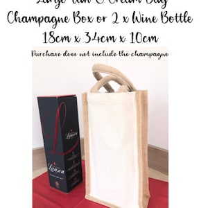 May include: A large tan and cream jute bag with a handle. The bag is 18 inches by 34 inches by 10 inches and can fit a champagne box or two wine bottles. The text "Large Tan & Cream Bag" is printed on the top of the image. The text "Champagne Box or 2 x Wine Bottle" is printed below the first line of text. The text "18cm x 34cm x 10cm" is printed below the second line of text. The text "Purchase does not include the champagne" is printed below the third line of text.