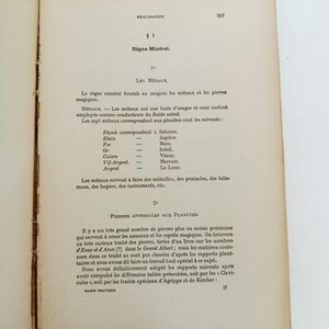 May include: Open book with aged, yellowed pages. Text in French includes the title "R&egrave;gne Min&eacute;ral" and lists metals and their planetary correspondences. The page is from a book on magic.