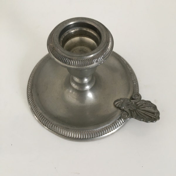 Old thumbscrew candle holder in vintage white iron