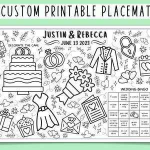 May include: A black and white printable wedding placemat with a wedding bingo game. The placemat features a cake, rings, a bouquet, a tuxedo, a lock, a calendar, a gift box, a cupcake, a dress, a love letter, and hearts. The text on the placemat reads "Decorate the Cake", "Justin & Rebecca", "June 13 2023", and "Wedding Bingo".