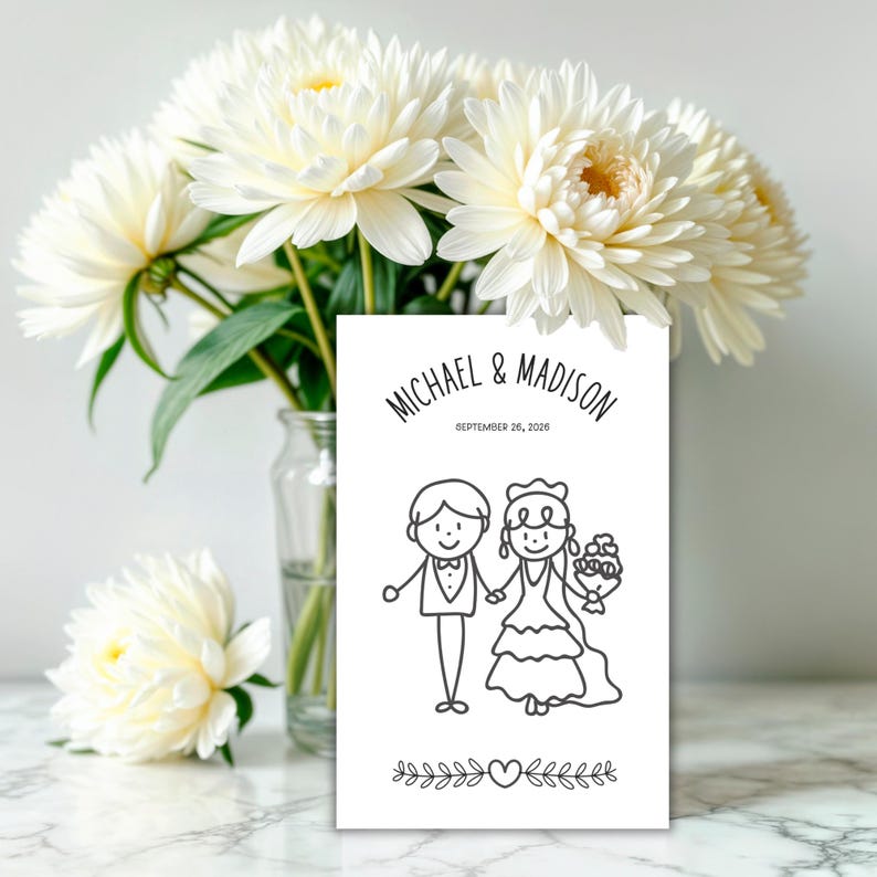 May include: A white wedding invitation card with the names "MICHAEL & MADISON" and the date "SEPTEMBER 26, 2026". The card features a black and white illustration of a bride and groom holding hands, with floral and heart accents.