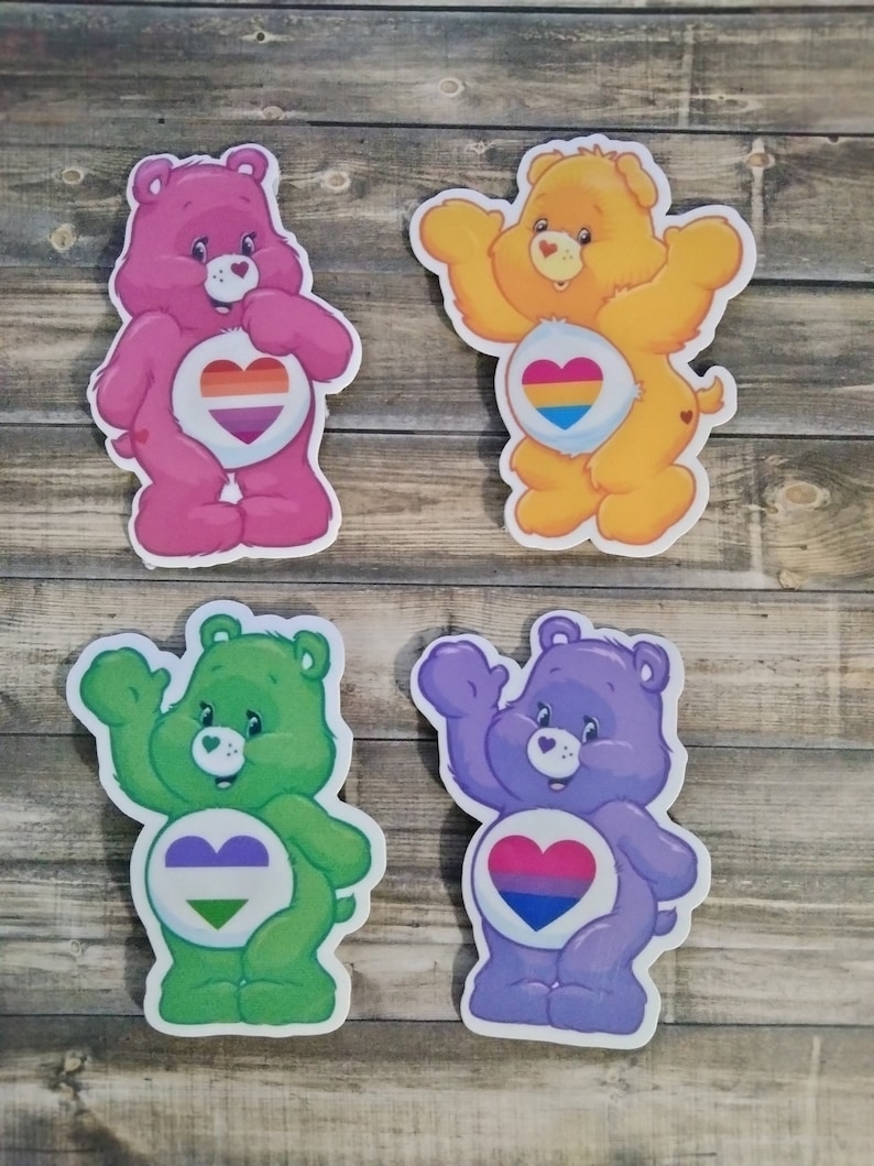 May include: Four Care Bear stickers with different colored fur and rainbow pride flags in their hearts. The bears are pink, yellow, green, and purple.