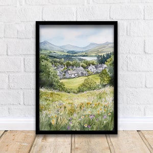May include: A watercolor painting of a small village nestled in a valley with rolling hills in the background. The village is surrounded by lush green fields and a small lake. The painting is framed in black.
