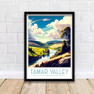 May include: A framed art print featuring a stylized landscape of the Tamar Valley. The artwork depicts a river winding through green fields and hills under a blue sky with fluffy clouds. The text "TAMAR VALLEY" and "AREA OF OUTSTANDING NATURAL BEAUTY" are at the bottom.