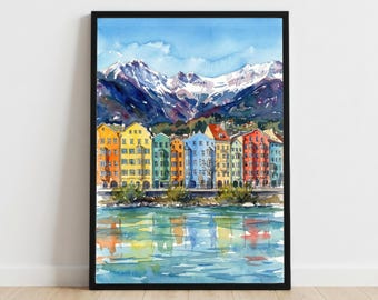 May include: Watercolor painting of colorful buildings along a river, with snow-capped mountains in the background. The buildings are painted in shades of yellow, green, blue, and red. The water reflects the buildings and the sky.