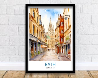 May include: A watercolor painting of a narrow street in Bath, England. The street is lined with buildings, and there is a church in the distance. The painting is in a black frame.