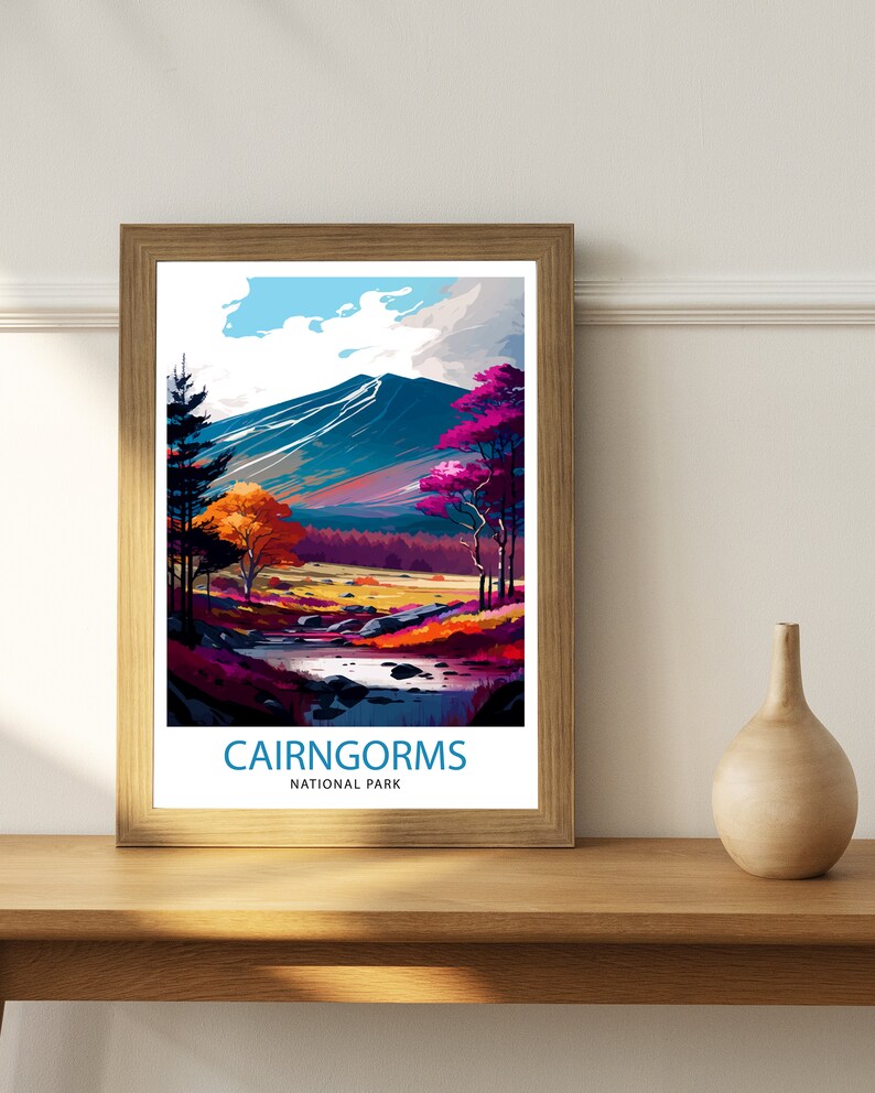 K&ouml;nnte beinhalten: Ein gerahmtes Poster mit einer farbenfrohen Illustration einer Bergkette mit einem Fluss, der durch sie flie&szlig;t. Das Poster tr&auml;gt den Text "Cairngorms National Park" am unteren Rand.