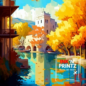 May include: A painting of a canal scene with a white building in the background. The canal is surrounded by trees with yellow and orange leaves. The water is blue and reflects the sky and trees. The painting is titled "INK'N' PRINTZ TRAVEL ART PRINTS".