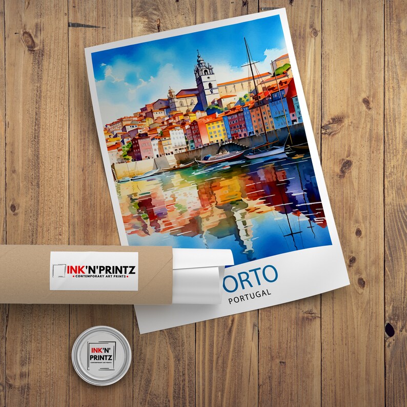May include: A watercolor painting of a cityscape with colorful buildings and boats on a river. The painting is titled "Porto, Portugal" and is framed in a white frame.