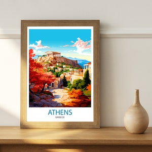 May include: A framed print of a colorful illustration of the Acropolis in Athens, Greece. The print features a view of the Acropolis from a lower elevation, with a path leading up to the ancient structure. The sky is blue with white clouds, and the trees are a mix of green and red.