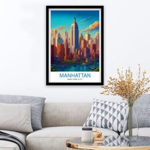 K&ouml;nnte beinhalten: Ein gerahmtes Poster mit einer farbenfrohen Illustration der Skyline von Manhattan, einschlie&szlig;lich des Empire State Building und anderer Wolkenkratzer. Das Poster tr&auml;gt den Text "MANHATTAN NEW YORK CITY" am unteren Rand.