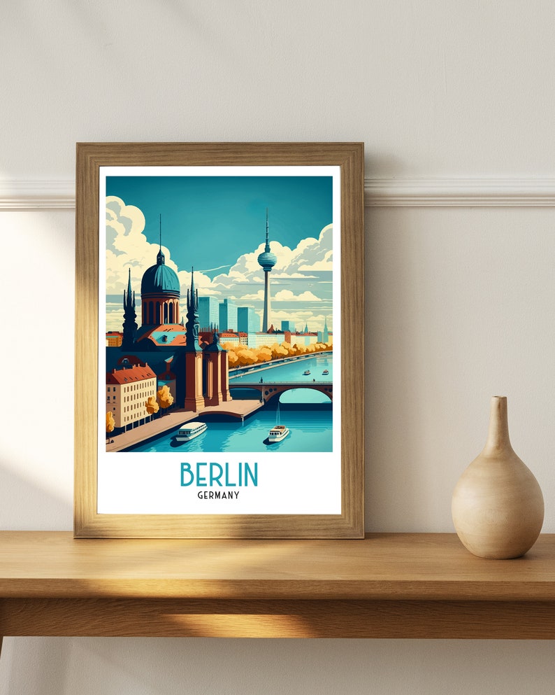 May include: A framed illustration of the Berlin skyline featuring the iconic Fernsehturm television tower, a dome-shaped building, and a bridge over a river. The illustration is in a vintage style with a blue, green, and yellow color palette. The text "BERLIN GERMANY" is printed below the illustration.