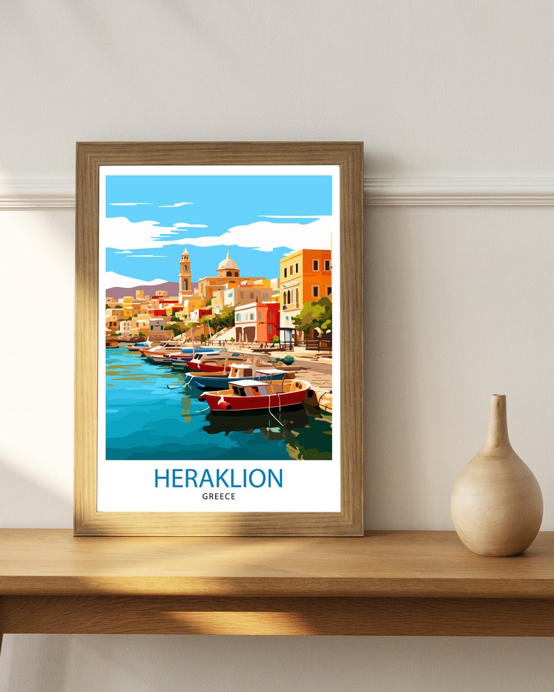 May include: A framed poster with a colorful illustration of a harbor scene in Heraklion, Greece. The poster features a row of colorful boats docked in a harbor with buildings in the background. The text "HERAKLION GREECE" is printed at the bottom of the poster.