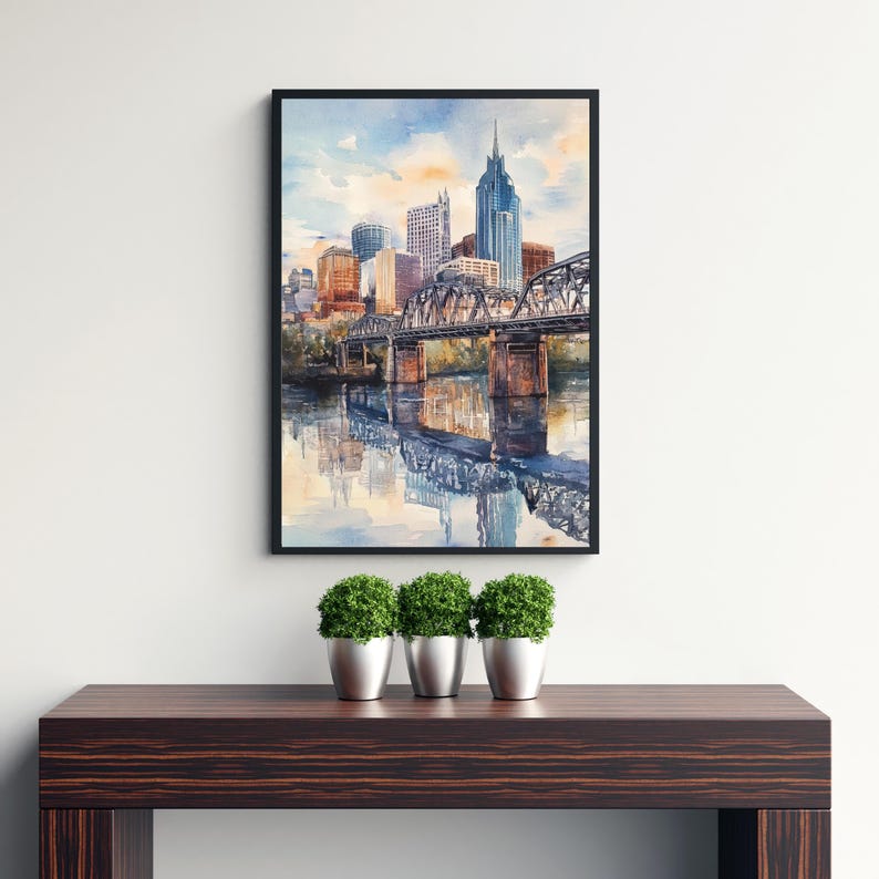 May include: A watercolor painting of the Nashville skyline with a bridge and reflections in the water.