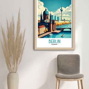 May include: A vintage travel poster featuring a colorful illustration of the Berlin skyline, including the iconic Fernsehturm television tower, a church, and a bridge over a river. The poster has the text "BERLIN GERMANY" at the bottom.