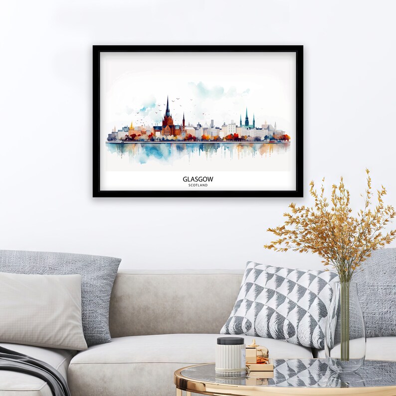 May include: A watercolor painting of the Glasgow skyline, featuring the city's iconic buildings and a reflection in the water below. The painting is framed in black and has the text "GLASGOW, SCOTLAND" at the bottom.