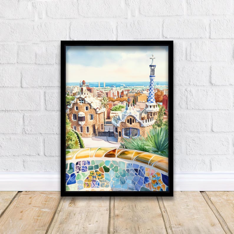 May include: Watercolor print of Park G&uuml;ell in Barcelona, Spain, framed in black. The artwork depicts the park's architecture, including the iconic mosaic benches and buildings with colorful, whimsical designs. The background shows the city and the sea.