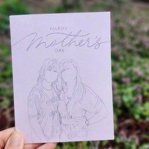 May include: A light purple card with the text "Happy Mother's Day" in cursive script. A pencil sketch of two women standing side-by-side is below the text.