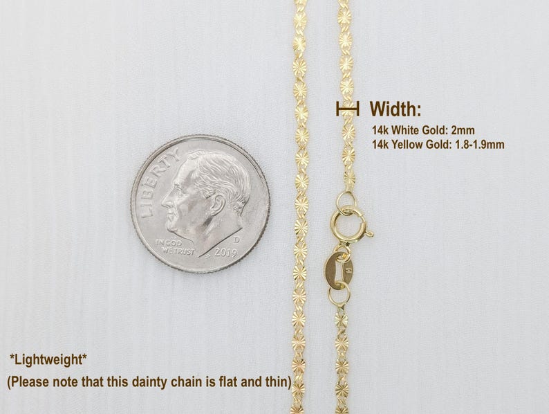 May include: A delicate gold chain necklace with a clasp. The chain is flat and thin, and the width is 2mm for 14k white gold and 1.8-1.9mm for 14k yellow gold. The chain is shown next to a US dime for size comparison.