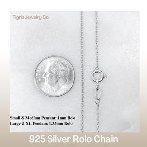 May include: A close-up of a silver 925 Rolo chain with a dime for size comparison. The chain is shown with a clasp and the text reads "Small & Medium Pendant: 1mm Rolo, Large & XL Pendant: 1.35mm Rolo". The brand name "Tigris Jewelry Co." is also visible.