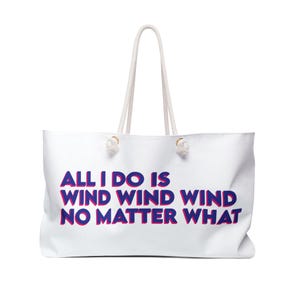 May include: White canvas tote bag with blue and red text that reads "All I do is wind wind wind no matter what".