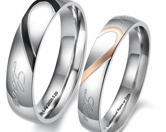 May include: Two silver rings with a heart design. One ring has a black heart outline, the other has a rose gold outline. The word "Love" is engraved on each ring. One ring is engraved with "Lily 2020.5.20" and the other with "Customized Name or Date".