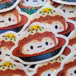 May include: A set of four holographic stickers featuring a cartoon illustration of a plate of food with a fried egg on top. The food is brown and white and has a cute face. The plate is red and has a blue rim.