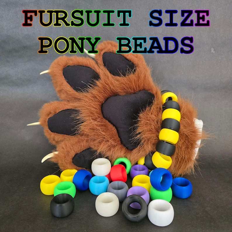 May include: A brown furry paw with black claws and a yellow and black beaded bracelet. A collection of colorful pony beads in various colors including red, blue, green, yellow, purple, and white.