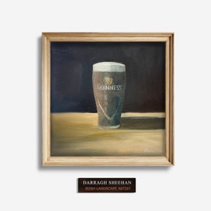 May include: A painting of a glass of Guinness beer on a wooden table. The glass is frosted and has the Guinness logo on it. The background is dark.