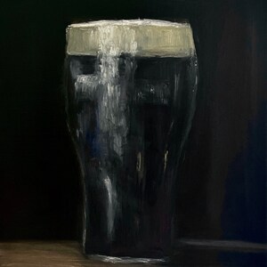May include: Oil painting of a pint of stout, a dark beer, with a creamy white head. The glass is a classic pint shape, filled with the dark liquid. The background is a deep black, and the painting is on a wooden surface.