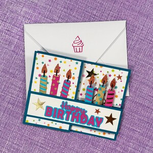 May include: A handmade birthday card with a white envelope featuring a pink cupcake stamp. The card has a teal border and displays the words "Happy Birthday" with colorful candles and star accents.