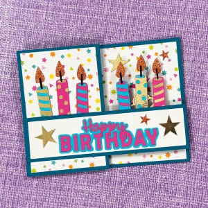 May include: A handmade birthday card with a teal border. The card features colorful candles with glitter flames and the words "Happy Birthday" in a bright pink and teal font. Gold star accents complete the design.