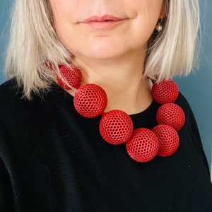 Model with  Handcrafted Beaded Maximalist Necklace with Vibrant Brutalist Pendant, statement necklace,  
iris apfel halskette,   
 iris apfel, 
 chunky necklace, 
 brutalist necklace, 
 3d printed jewelry,  
maximalist jewelry