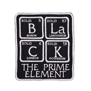 May include: A rectangular black embroidered patch featuring four white periodic table-style squares for Boron, Lanthanum, Carbon, and Potassium, spelling out BLACK. Below the squares, the text reads THE PRIME ELEMENT in white capital letters.