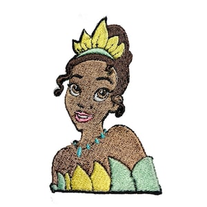 May include: Embroidered patch featuring a cartoon princess with brown skin, wearing a yellow and green crown and a turquoise necklace. The patch has a detailed, textured appearance, suitable for clothing or accessories.