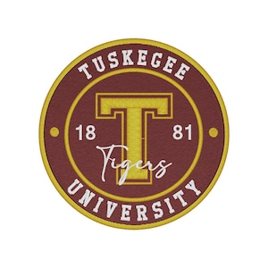 May include: Embroidered patch featuring the Tuskegee University seal. The design includes a maroon background with a gold border and lettering. The text reads "Tuskegee University" and "Tigers", with the founding year "1881".