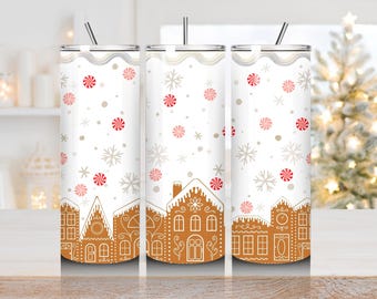 May include: White insulated tumbler with a gingerbread house design. The tumbler features a repeating pattern of gingerbread houses, snowflakes, and red and white peppermint candies. Includes a silver straw.