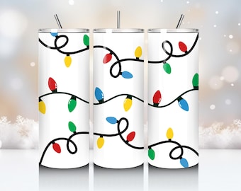 May include: Three white insulated tumblers with black straws, each decorated with a string of colorful Christmas lights. The lights are red, green, blue, and yellow, with black wiring. The tumblers are designed for cold beverages.