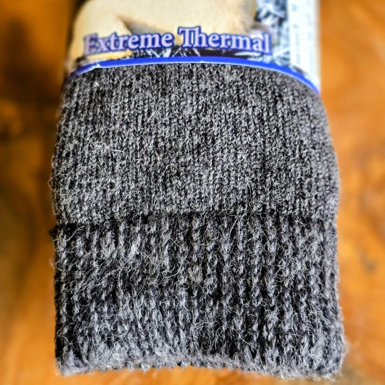 May include: A pair of dark gray thermal socks with the words "Extreme Thermal" printed on the packaging.