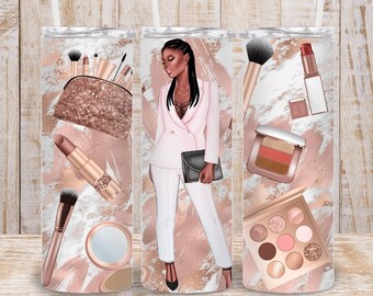 May include: Three stainless steel tumblers with a rose gold and white marble design. The tumblers feature a woman in a white suit, makeup brushes, lipstick, and eyeshadow palettes.