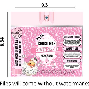 May include: A pink Christmas Cheer Spray bottle, 9.3 inches wide and 8.34 inches tall, with a Santa Claus graphic and snowflake pattern. The label reads "New Christmas Cheer Spray" and "Crisp Festive Scent".