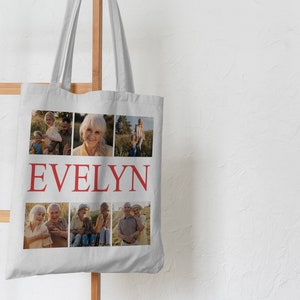 May include: A white canvas tote bag with a collage of family photos and the name "EVELYN" printed in red.