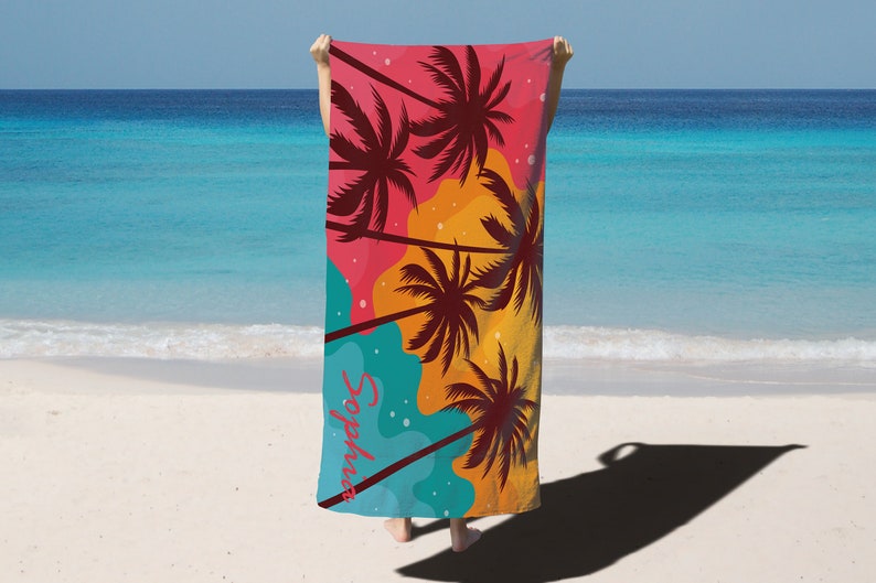 May include: A beach towel with a colourful design featuring palm trees and the text "#sunnydays".