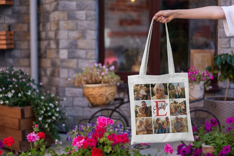 May include: White canvas tote bag with a photo collage of a family. The photos are arranged in a grid pattern and feature a red letter "E" with the name "Evelyn" written in cursive.