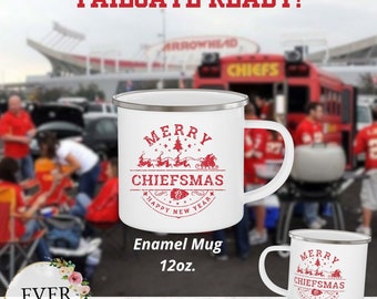 May include: White enamel mug with a red design that says "Merry Chiefmas Happy New Year" with a cartoon image of Santa Claus and reindeer. The mug is 12 ounces.